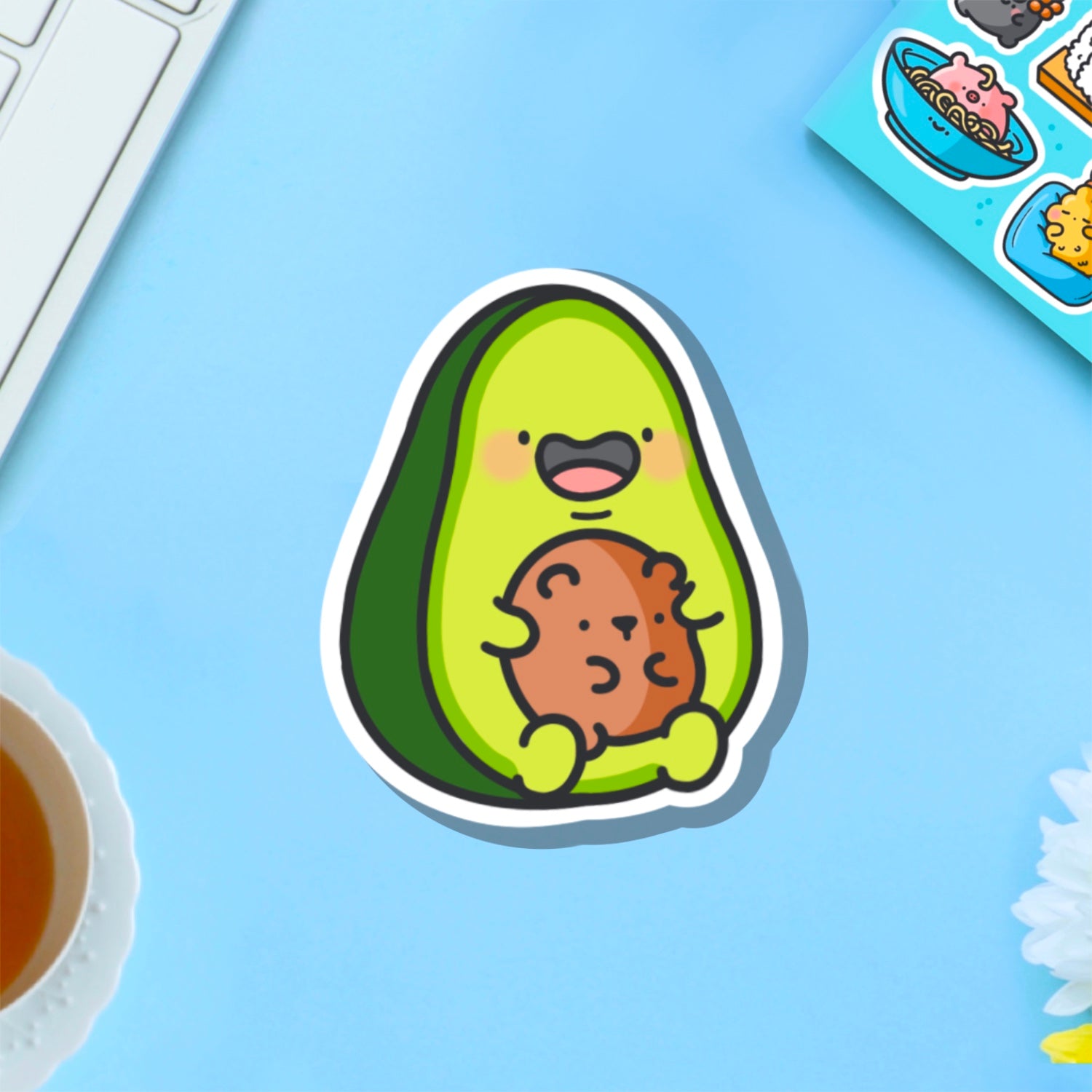 Avocado with bear vinyl sticker on blue table