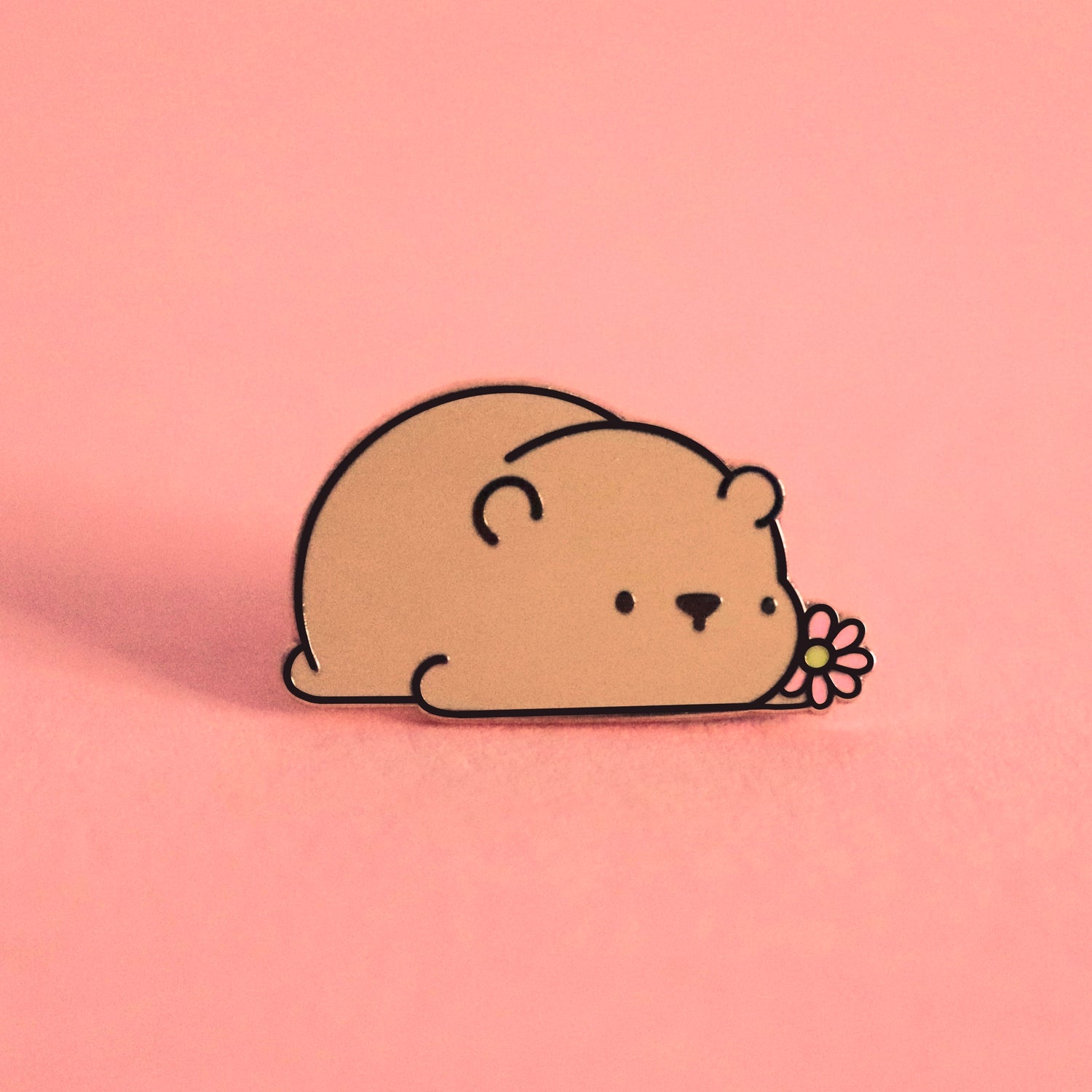 Brown bear enamel pin on pink background