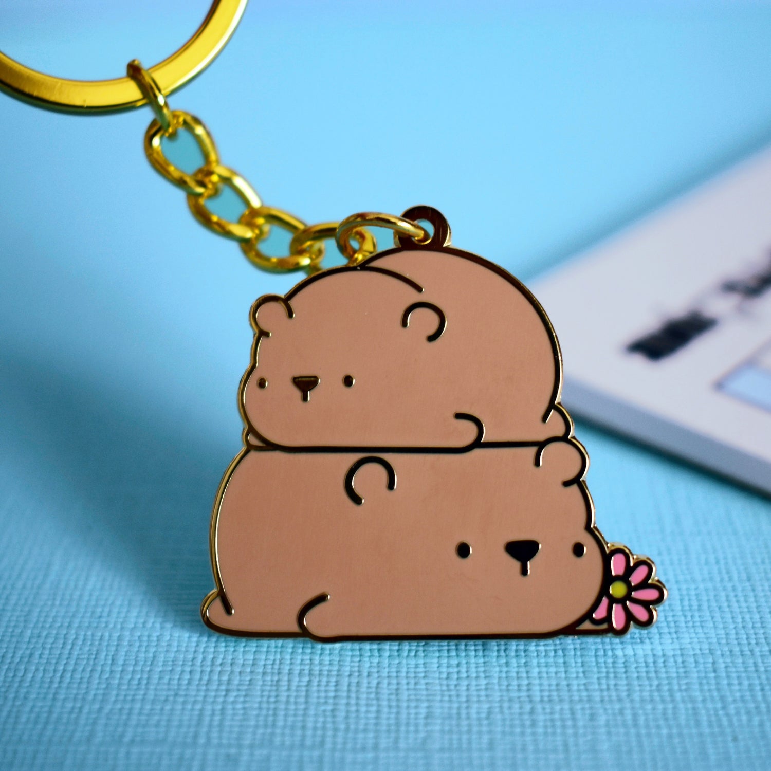 Bear keyring with notepad on blue background