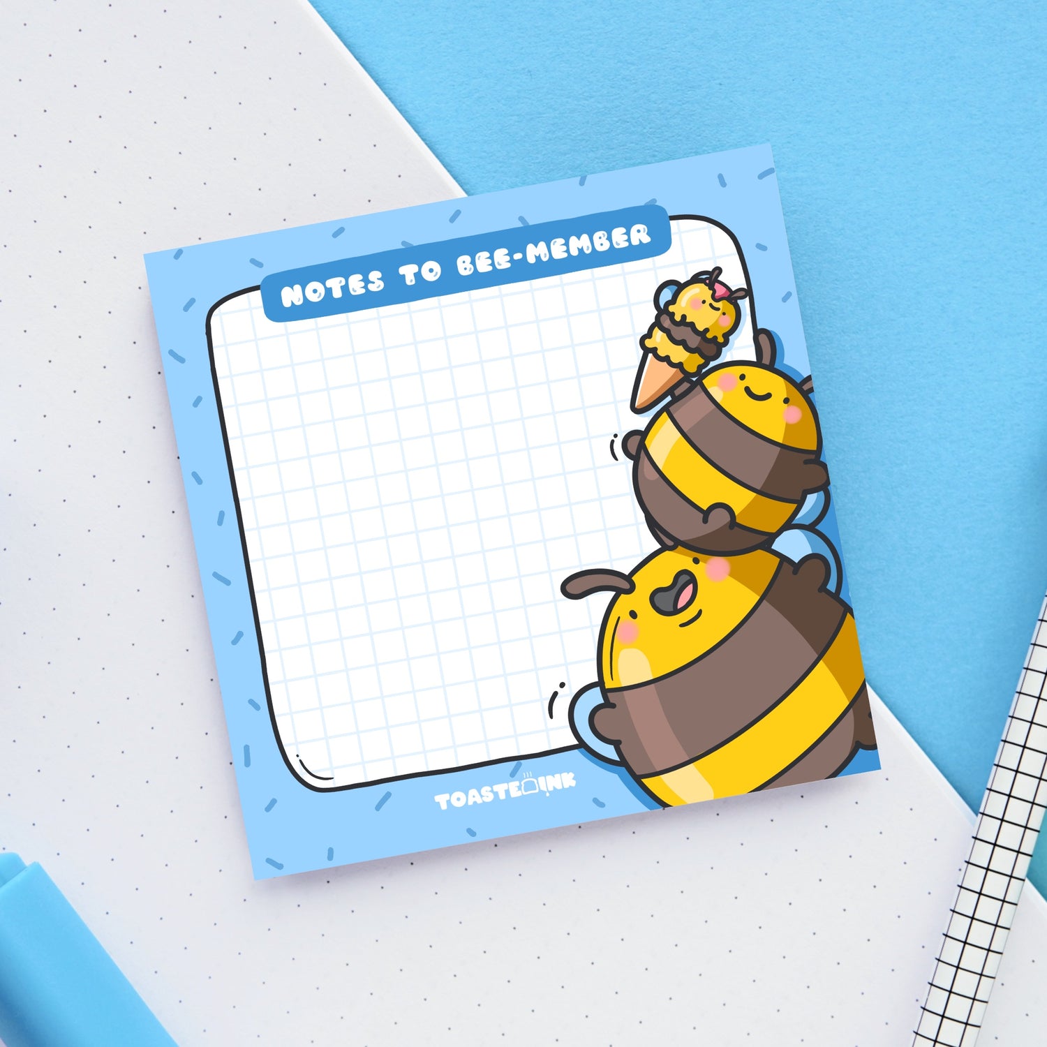 Bee sticky Notes on blue and white table