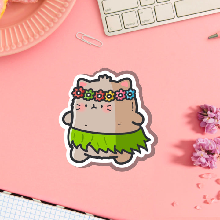 Cat in a grass skirt vinyl sticker on pink table