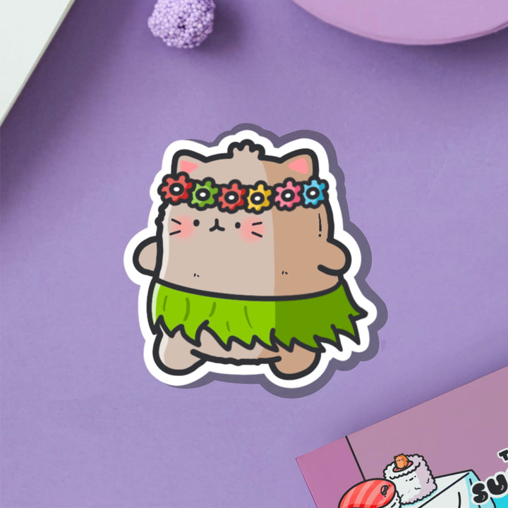 Cat in a grass skirt vinyl sticker on purple table