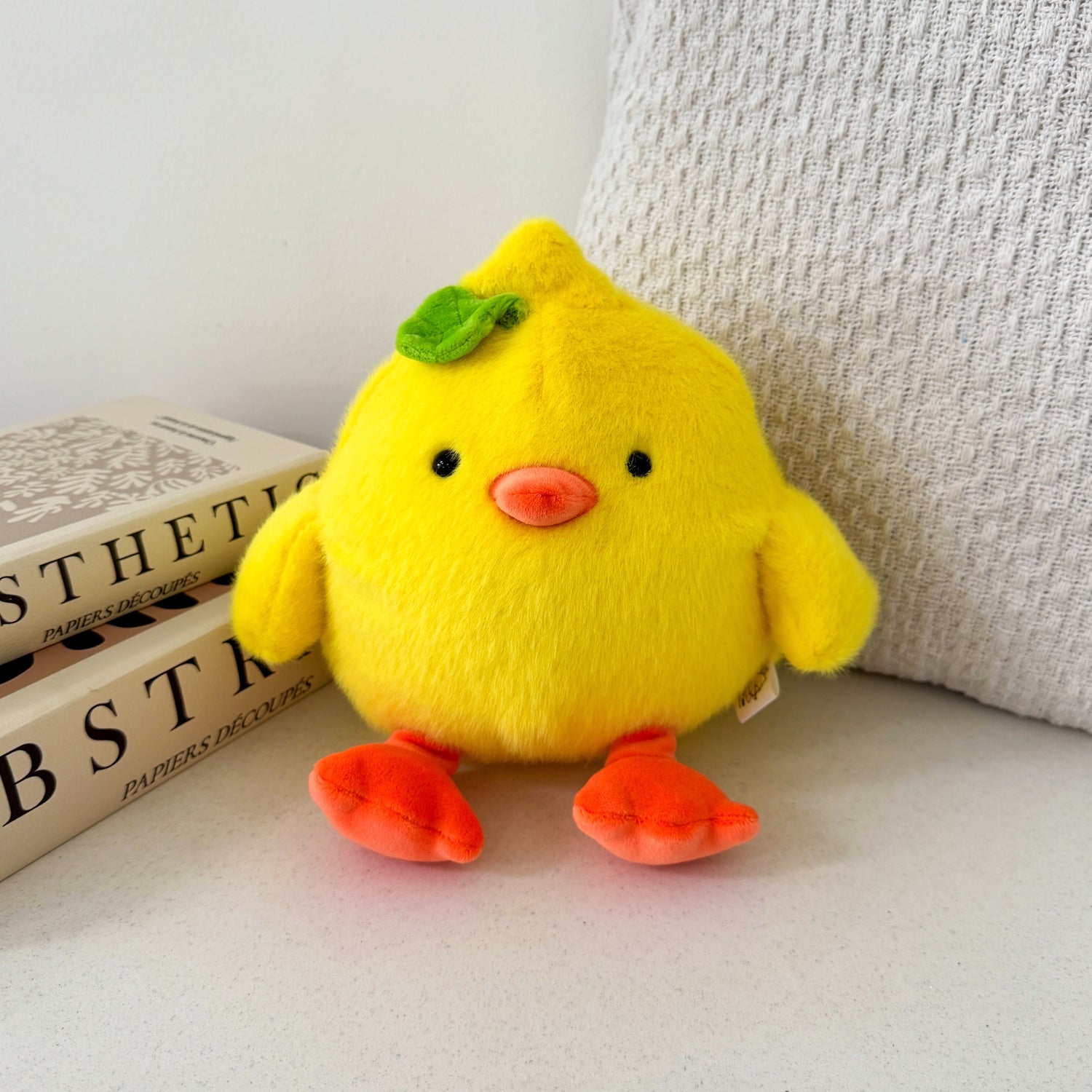 Chick Plush with beige cushion and books