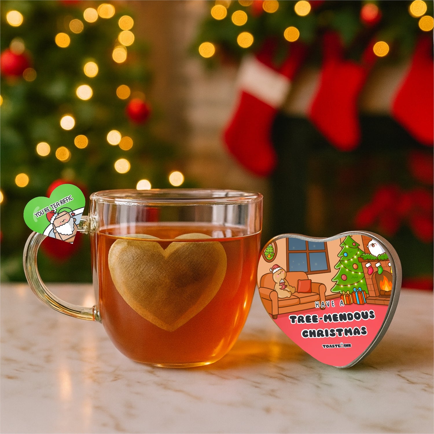 Heart-shaped tea bag in a glass mug with Christmas decorations in the background