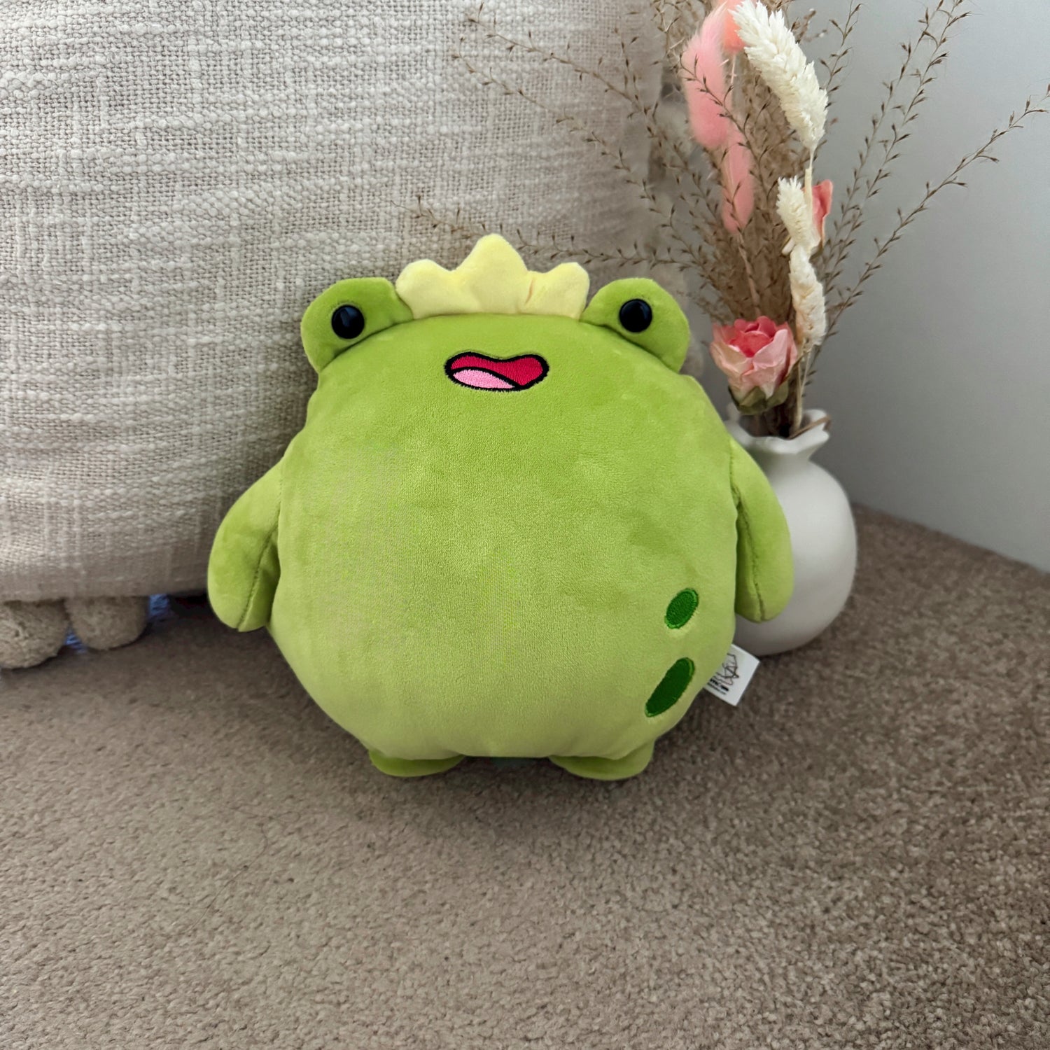 Frog plush toy with cushion and flowers
