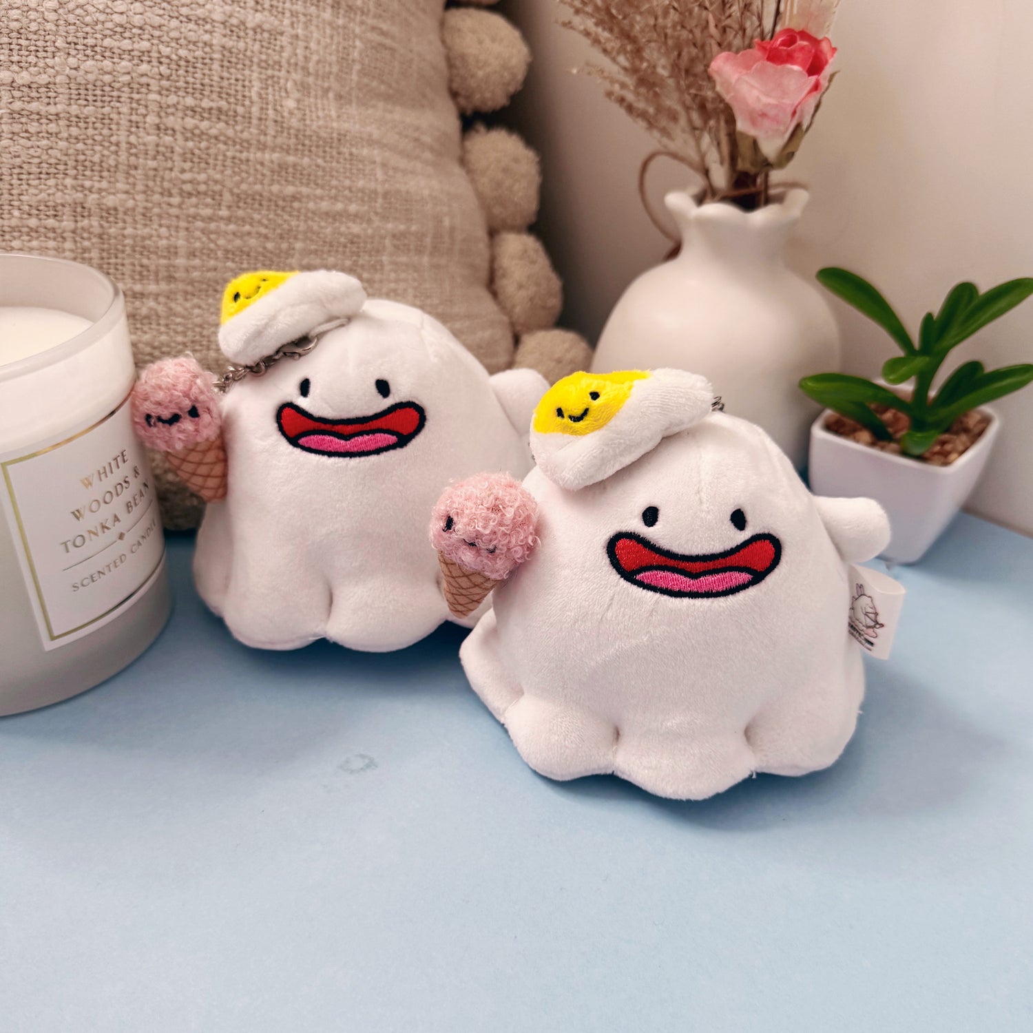 Two matching ghost plush keychains with kawaii ice cream and egg hats
