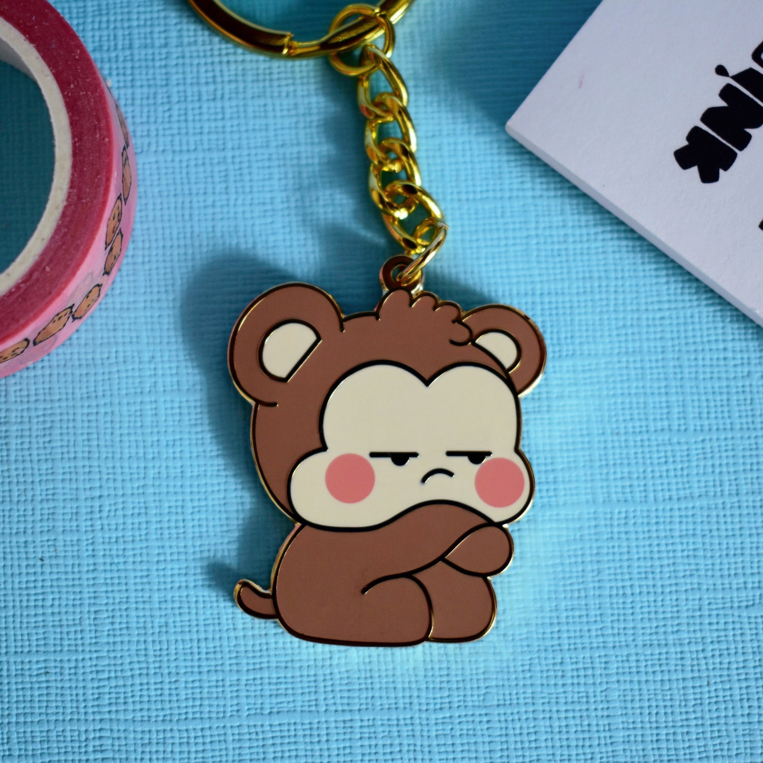 Grumpy monkey keyring on blue table
