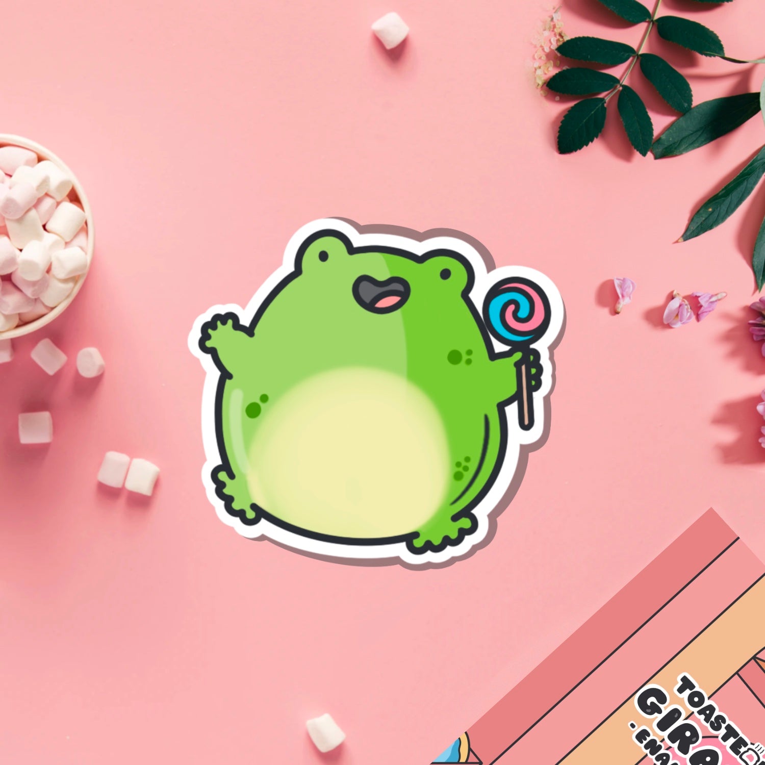 Jumping frog vinyl sticker on pink table