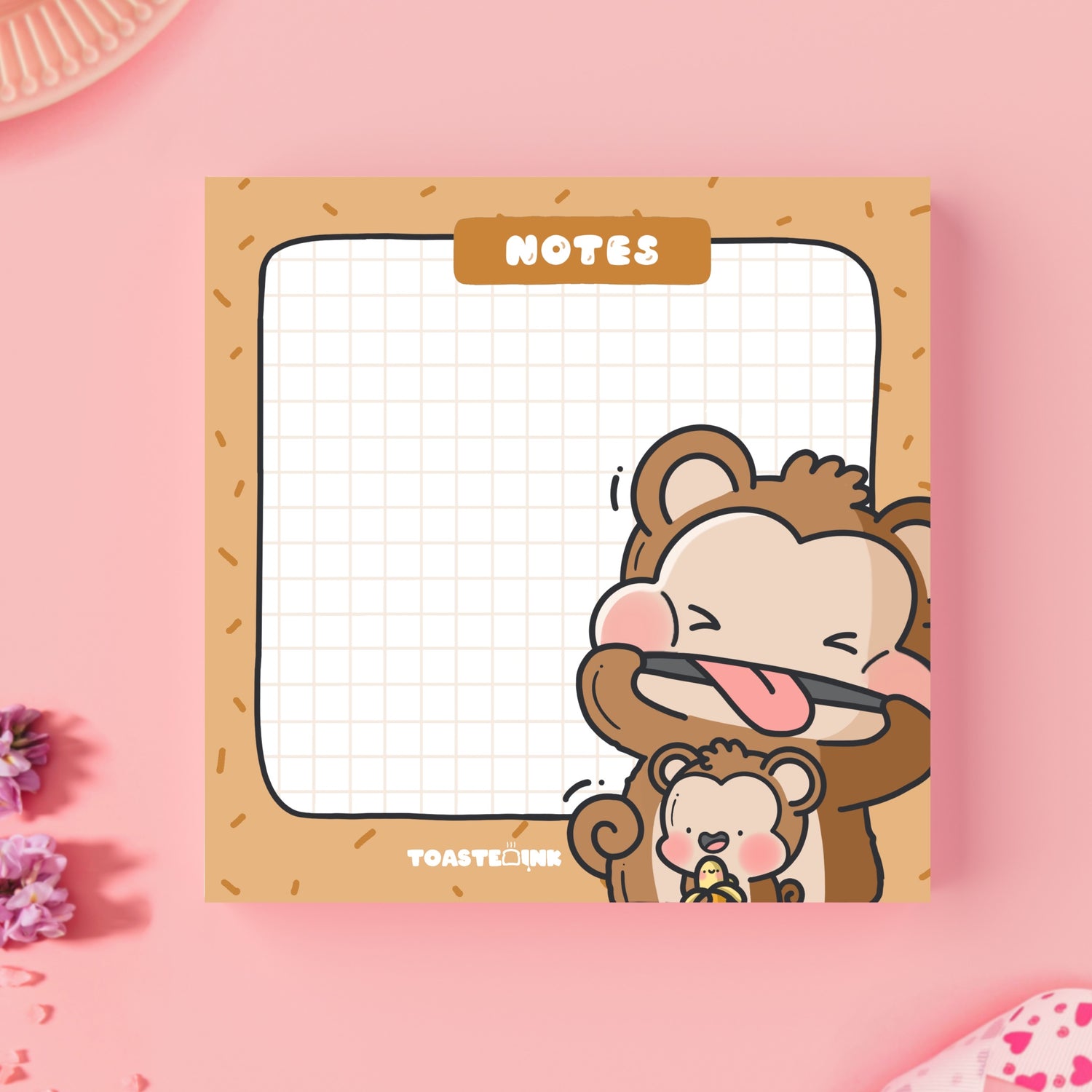 Monkey sticky notes on pink table