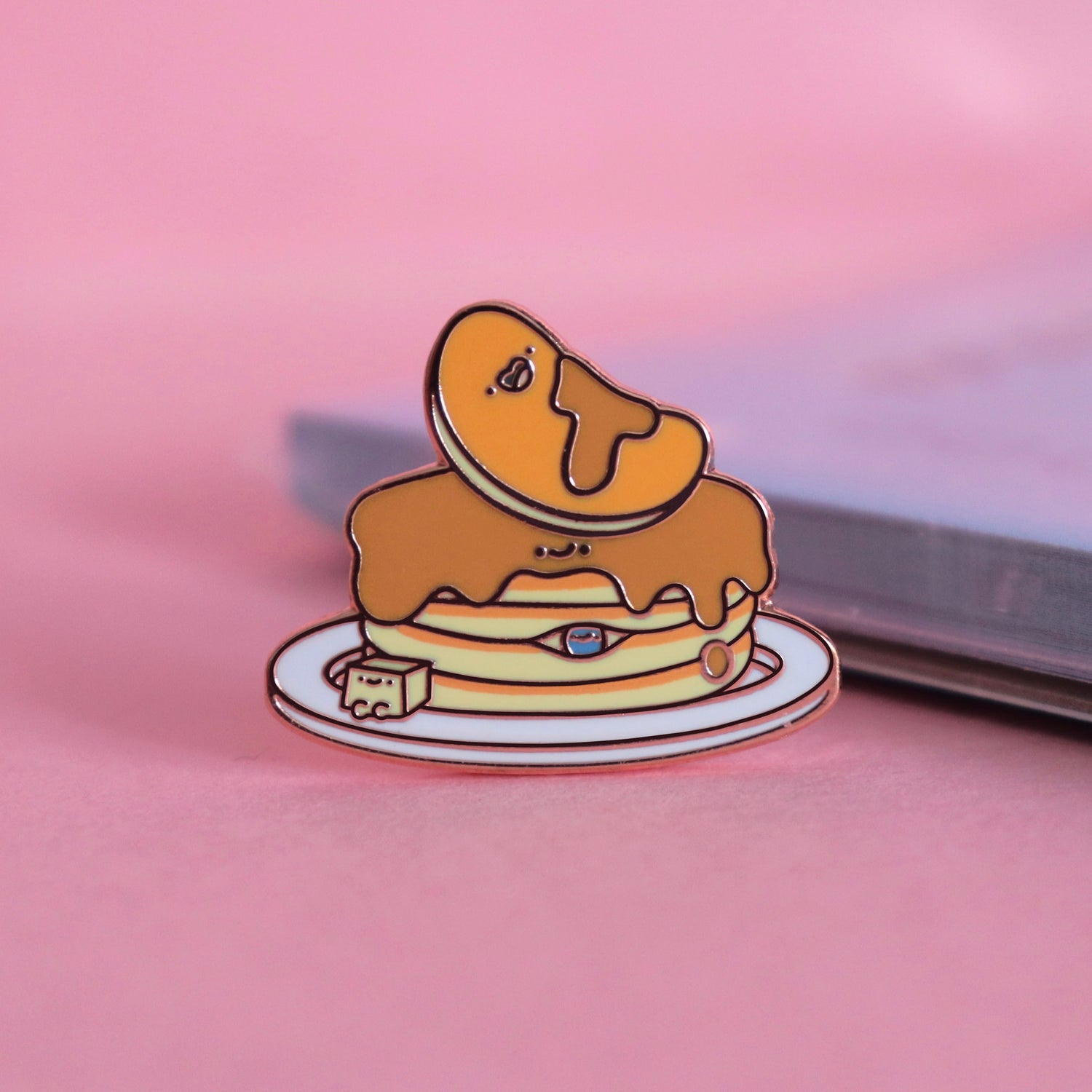 Pancakes enamel pin on pink table with notepad