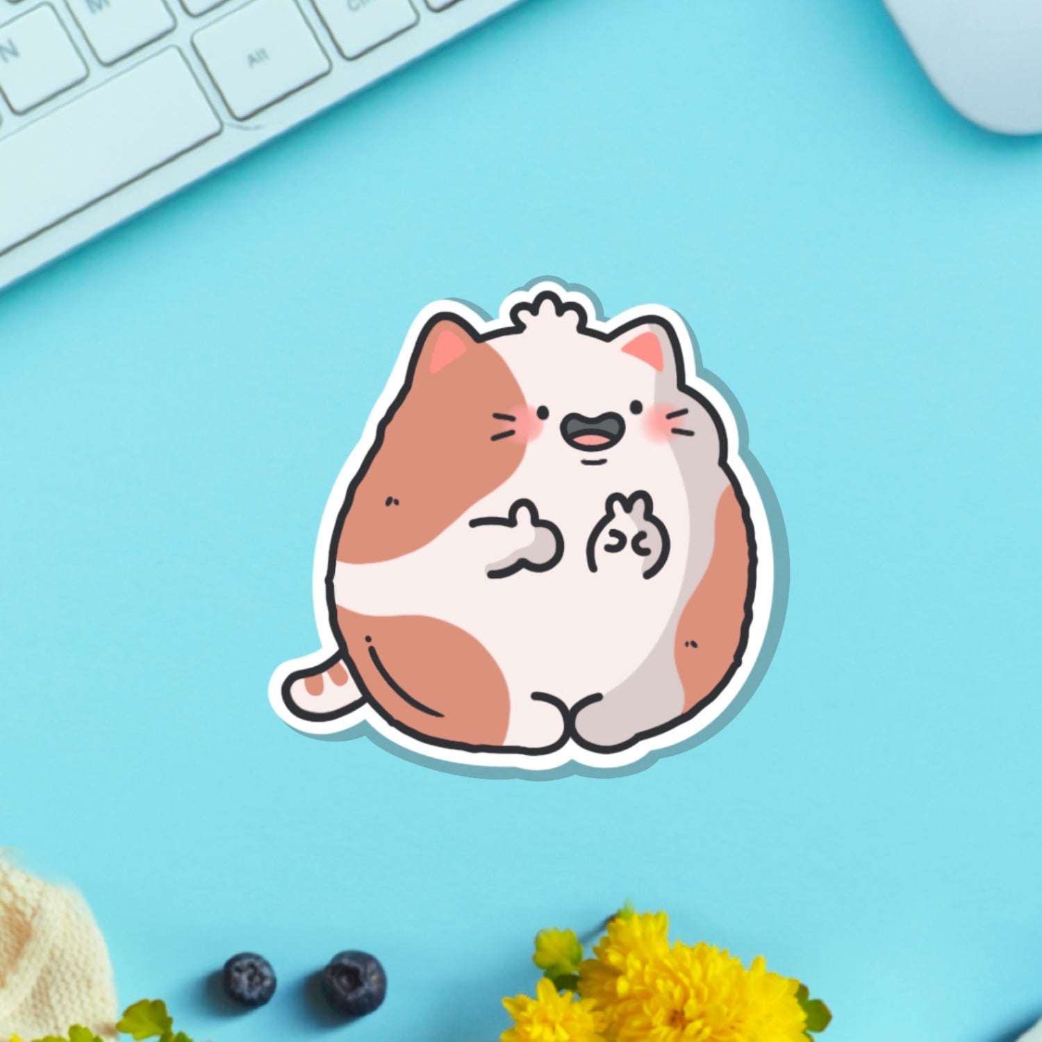 cat with peace sign vinyl sticker on blue table with keyboard