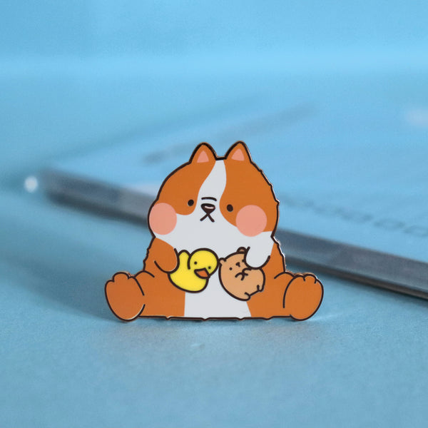 Dog Enamel pin on blue table with notebook