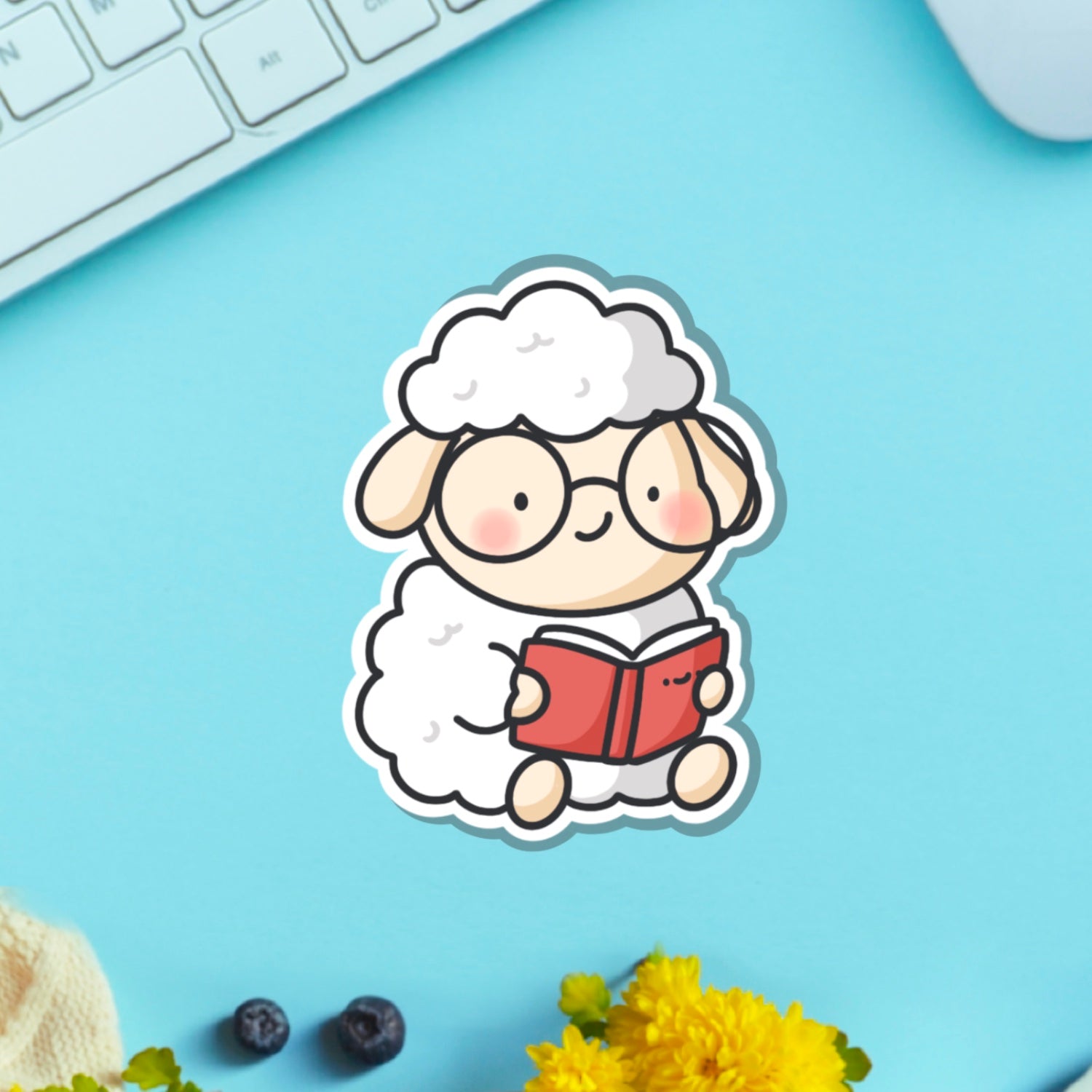 Reading sheep vinyl sticker on blue table with keyboard