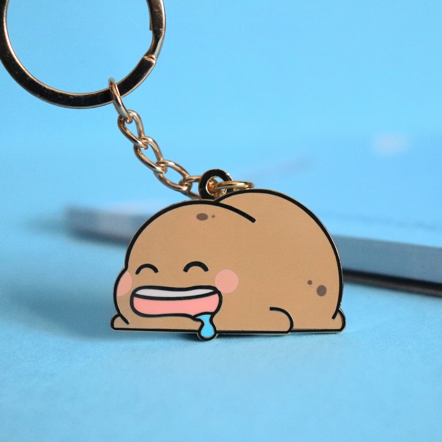 Potato keyring on blue background