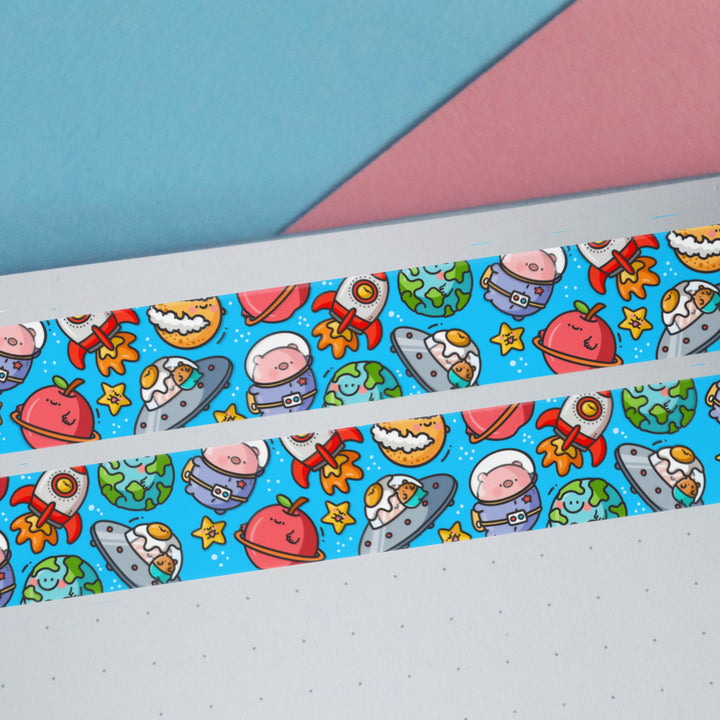 Space washi tape on blue and pink desk with notebook