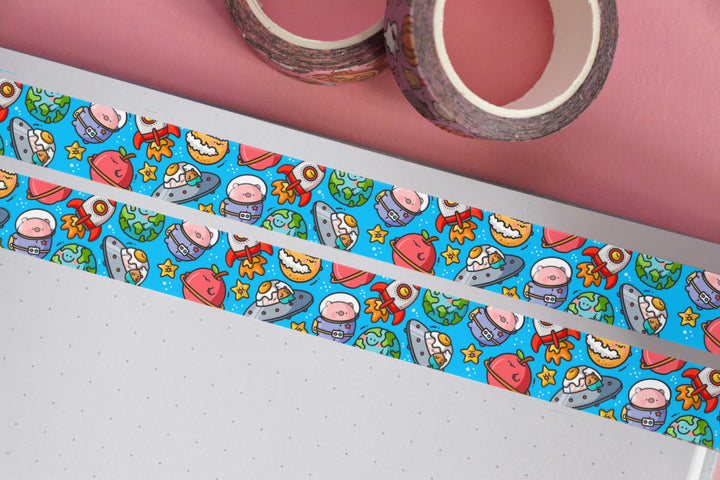 Space washi tape on pink table with 2 rolls of washi tape