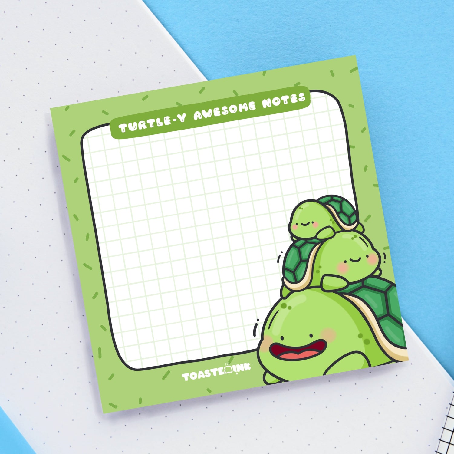Turtle sticky notes on blue and white desk