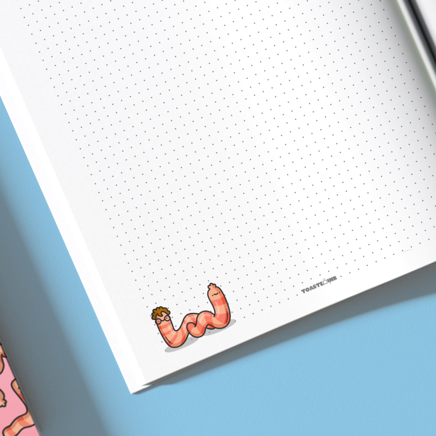 Close up of dot grid notebook with worm