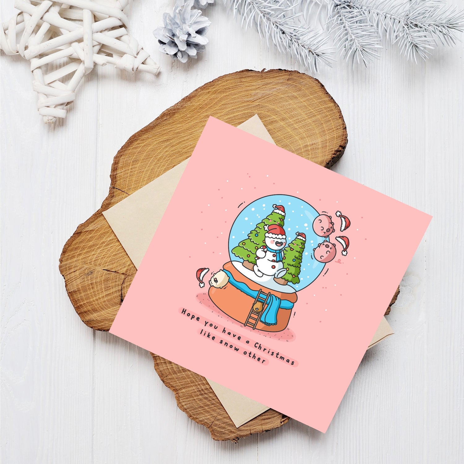 Christmas snowglobe card on wooden block