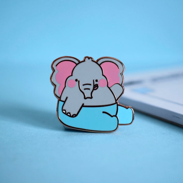 Elephant enamel pin on blue table