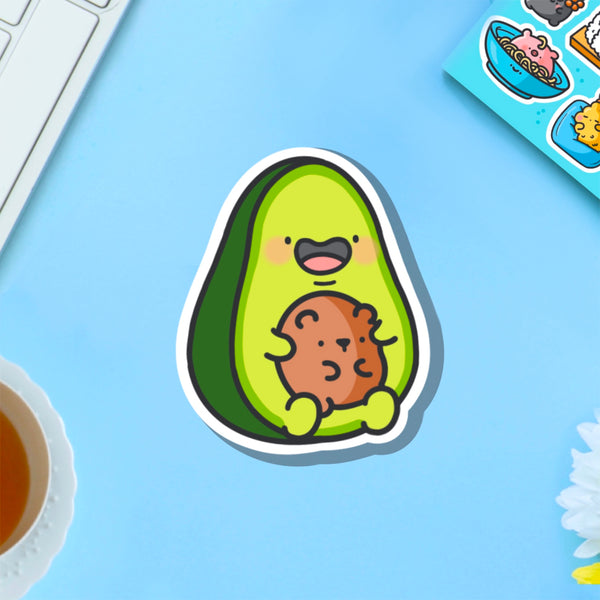 Avocado with bear vinyl sticker on blue table