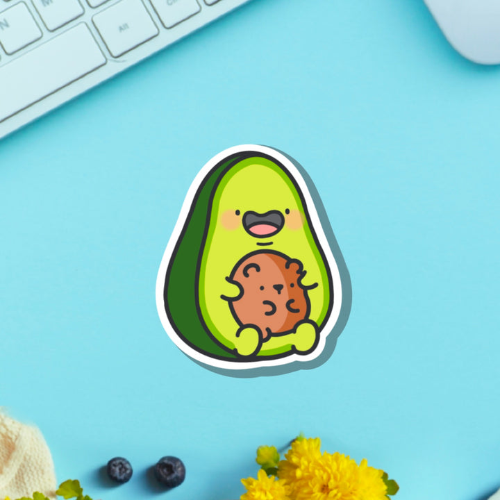 Avocado with bear vinyl sticker on blue table with keyboard