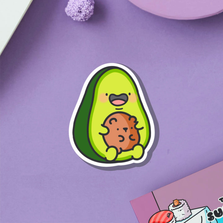 Avocado with bear vinyl sticker on purple table