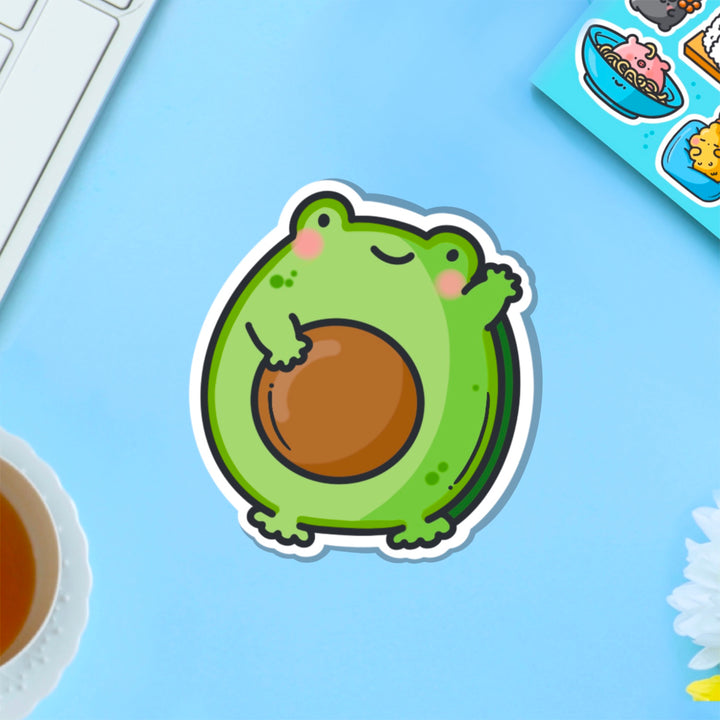 Avocado frog vinyl sticker on blue table