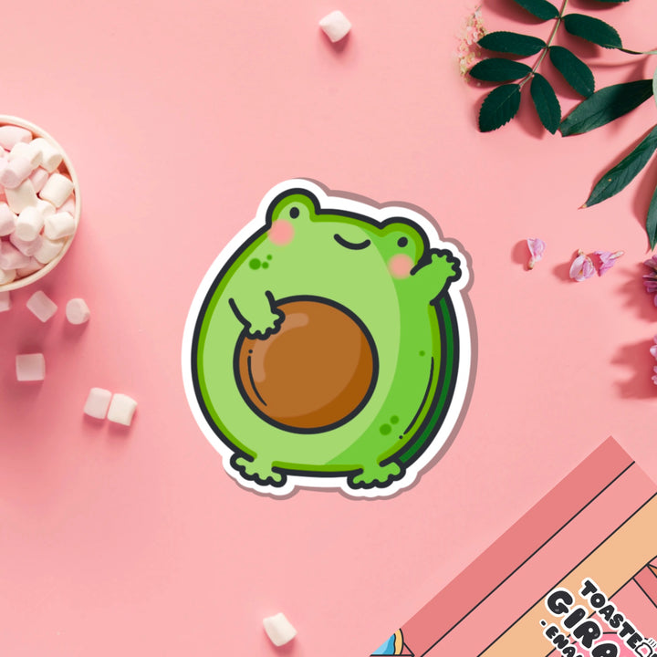 Avocado frog vinyl sticker on pink table