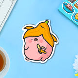 Pig with a banana vinyl sticker on blue table