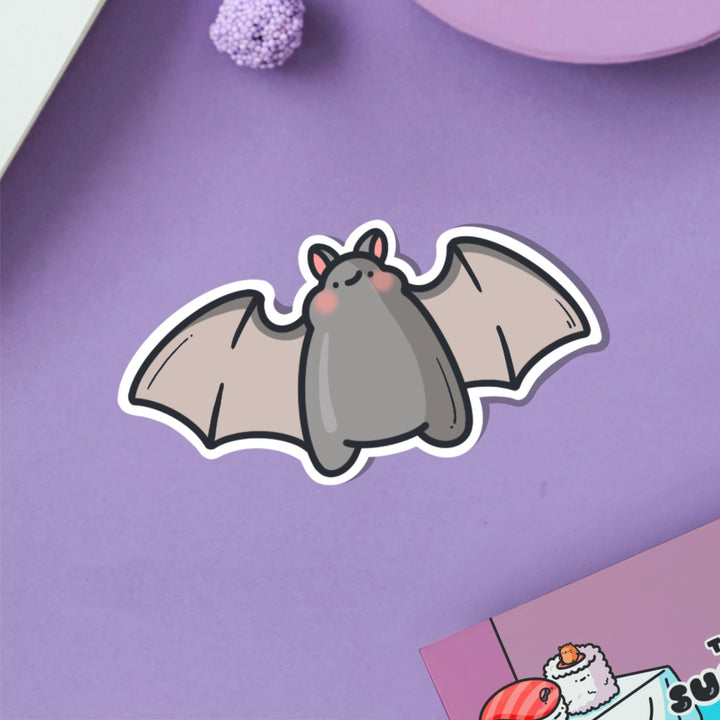 Bat vinyl sticker on purple table