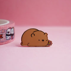 Brown bear enamel pin on pink table
