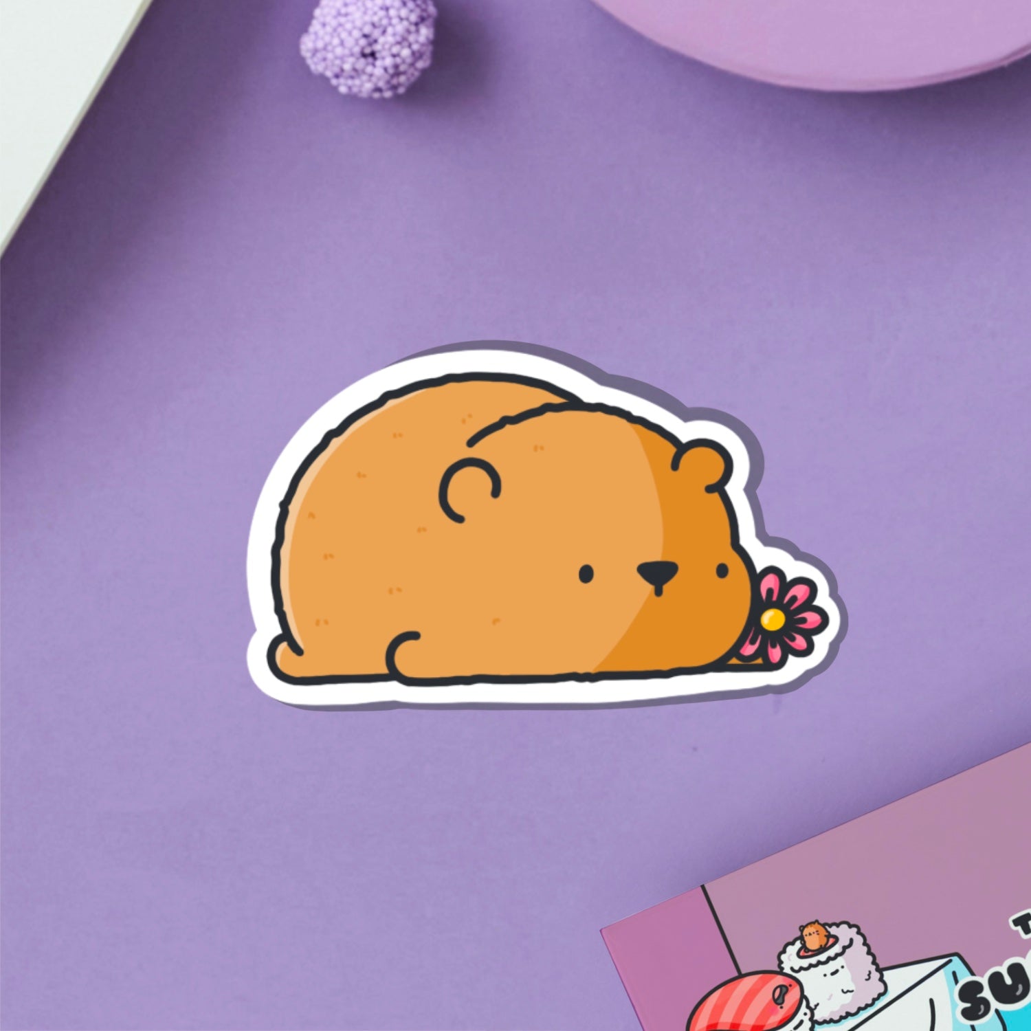 Bear with a flower vinyl sticker on purple table