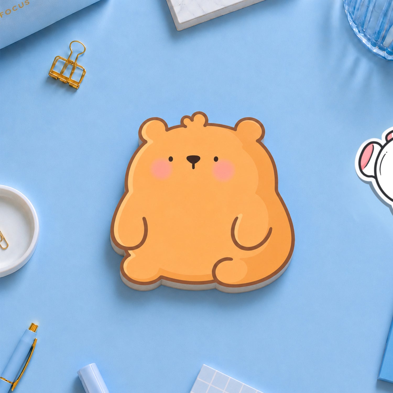 Bear shaped sticky notes on blue table with stationery 