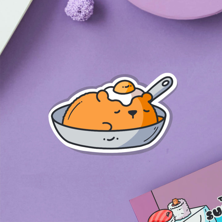 Bear in a frying pan vinyl sticker on purple table