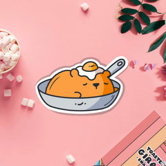 Bear in a frying pan vinyl sticker on pink table