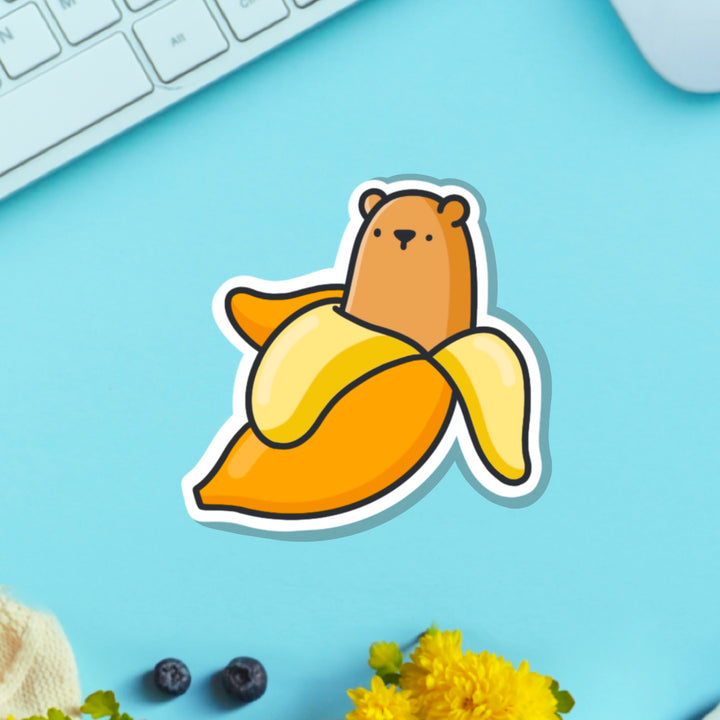 Bear banana vinyl sticker on blue table with keyboard