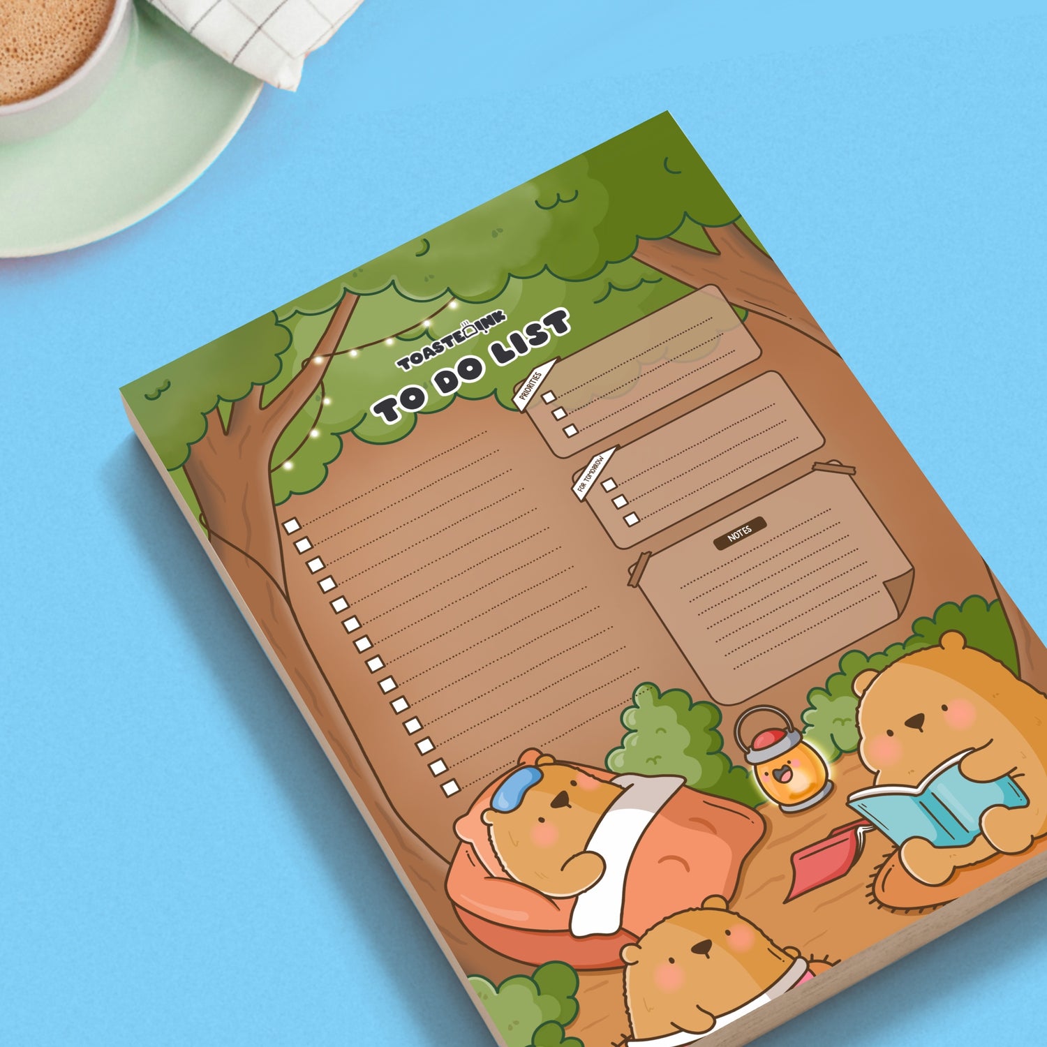 Bear to do list notepad on a blue table with mug of coffee