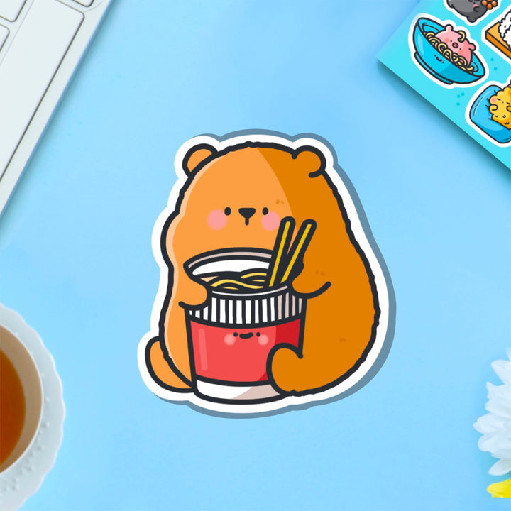 Bear with noodles vinyl sticker on blue table