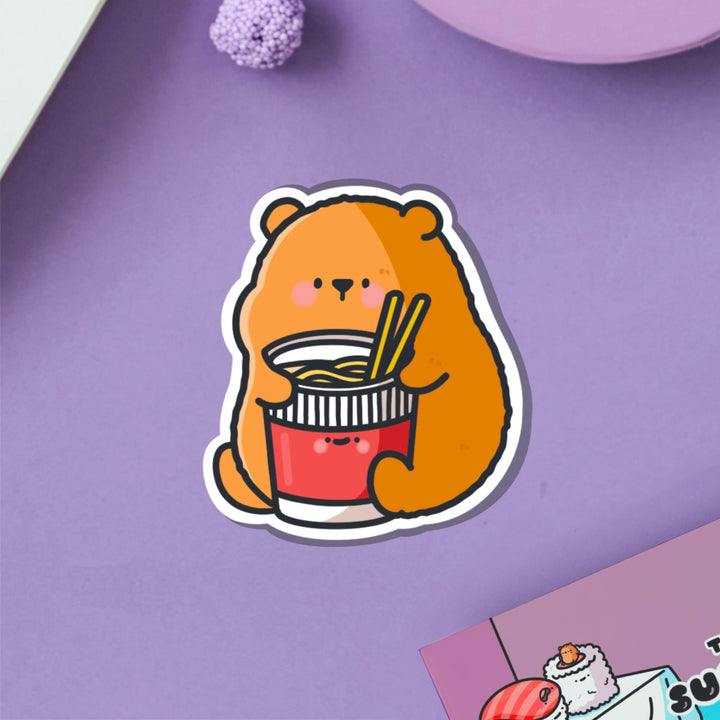 Bear with noodles vinyl sticker on purple table