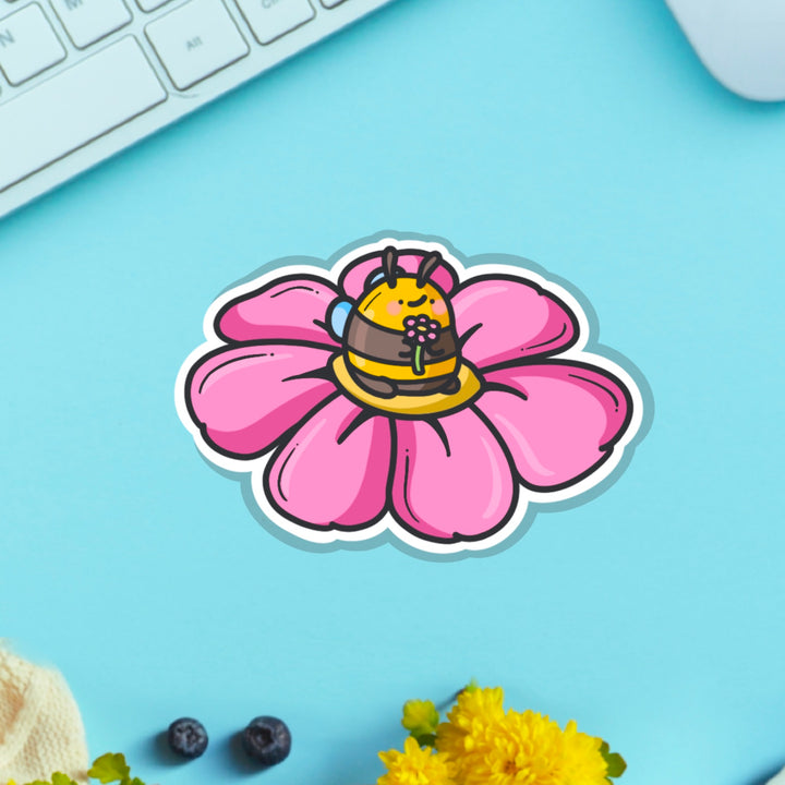 Bee on a flower vinyl sticker on table with keyboard