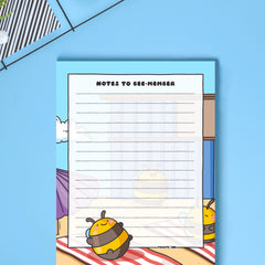 A6 Bee notepad  on blue desk close up