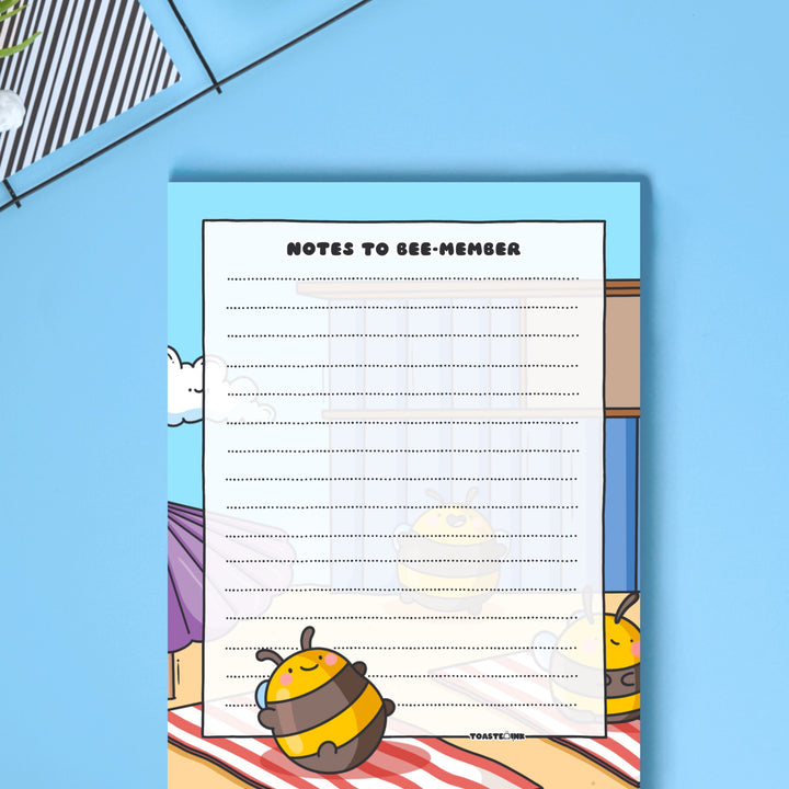 A6 Bee notepad  on blue desk close up