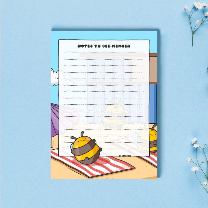 A6 Bee notepad  on blue table with flowers