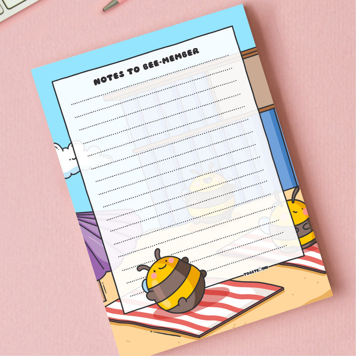 A6 Bee notepad  on pink desk