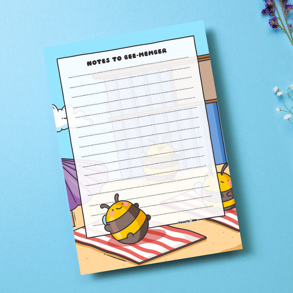 A6 Bee notepad  on blue table