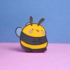 Bee enamel pin on pink and blue background