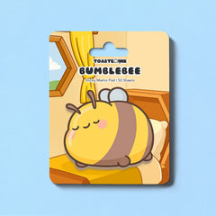Bee sticky notes on backing card and blue table