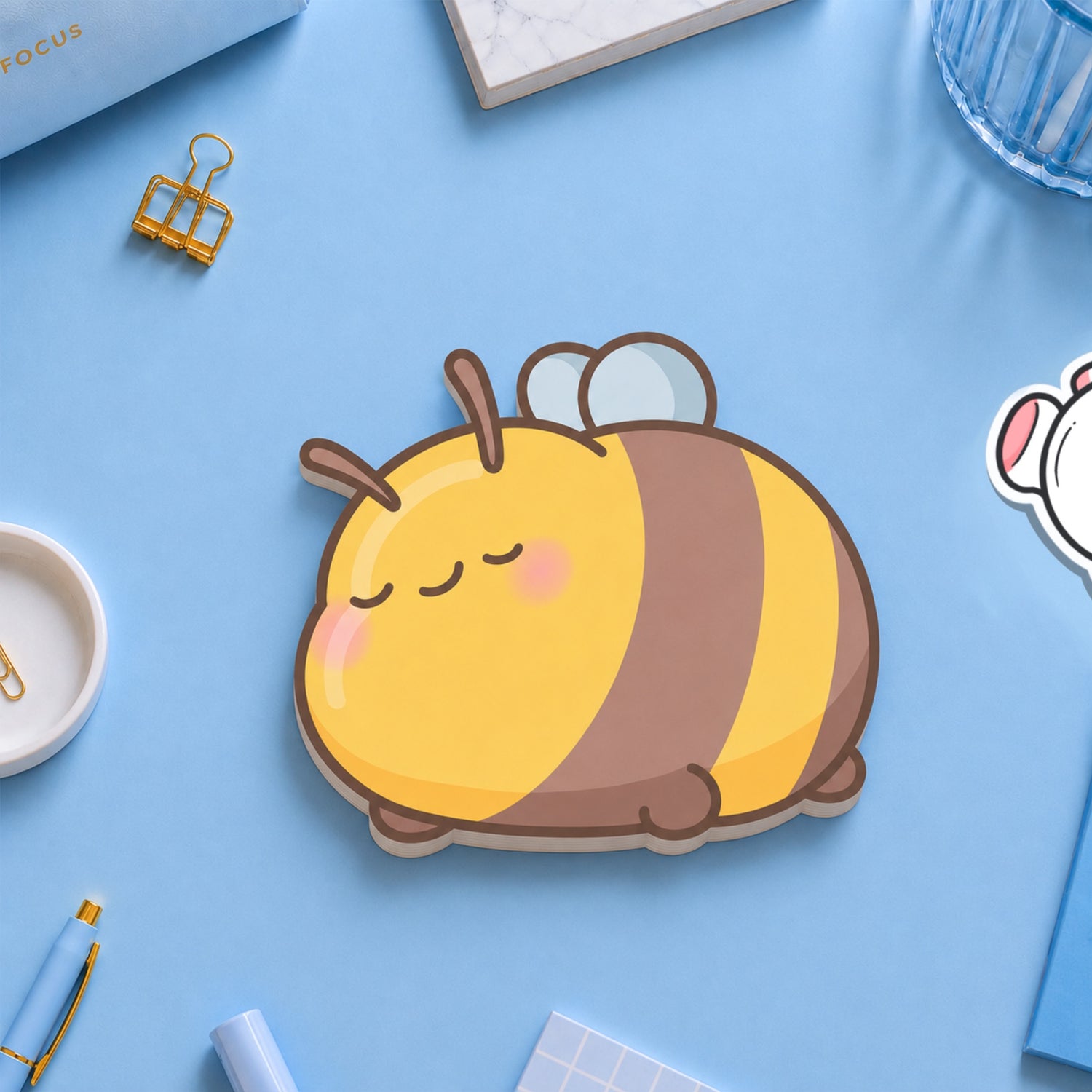 Bee shaped sticky notes on blue table with stationery