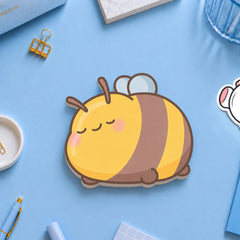 Bee shaped sticky notes on blue table with stationery